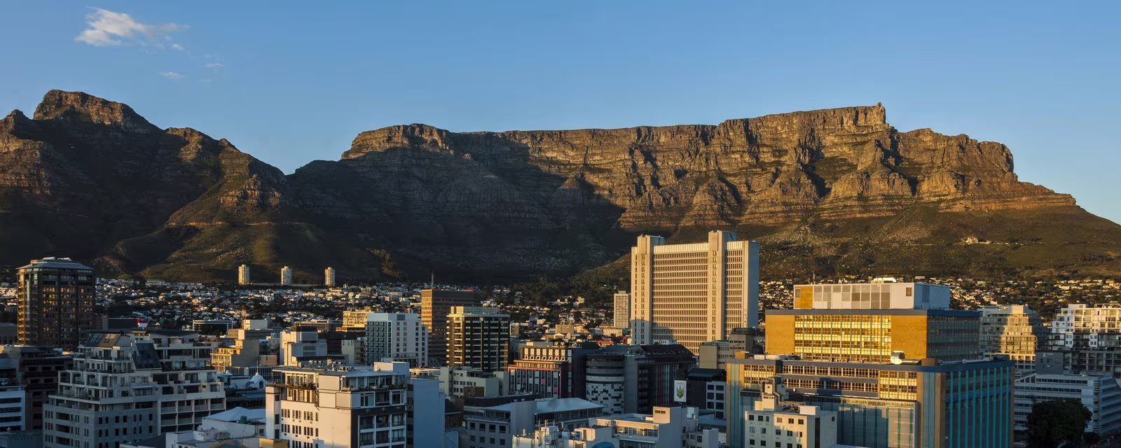 Table Mountain rising behind the Cape Town City Bowl at dawn